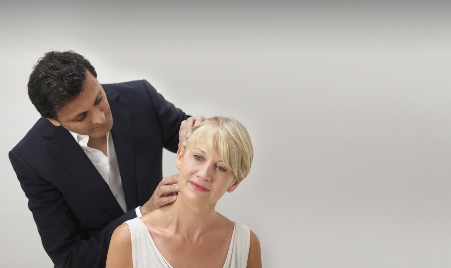 The uk's best facelift surgeon Rajiv Grover examining a facelift patient