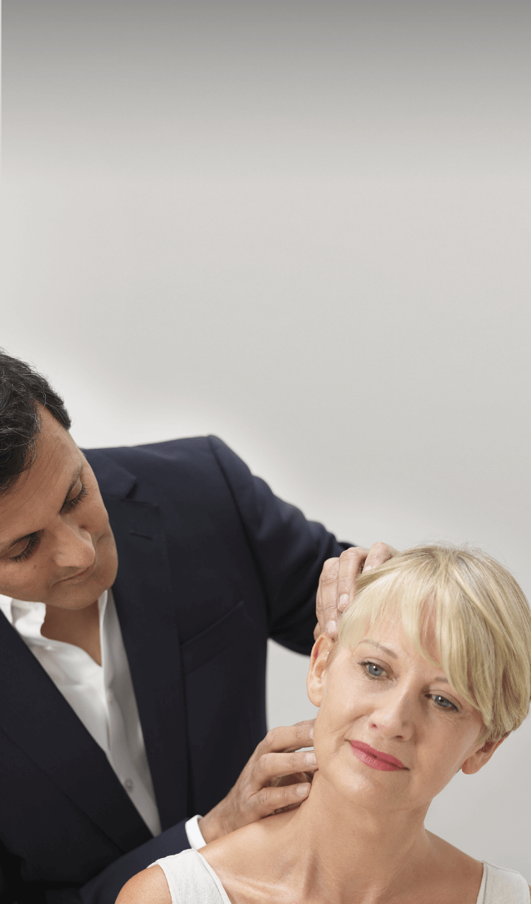 The uk's best facelift surgeon Rajiv Grover examining a facelift patient