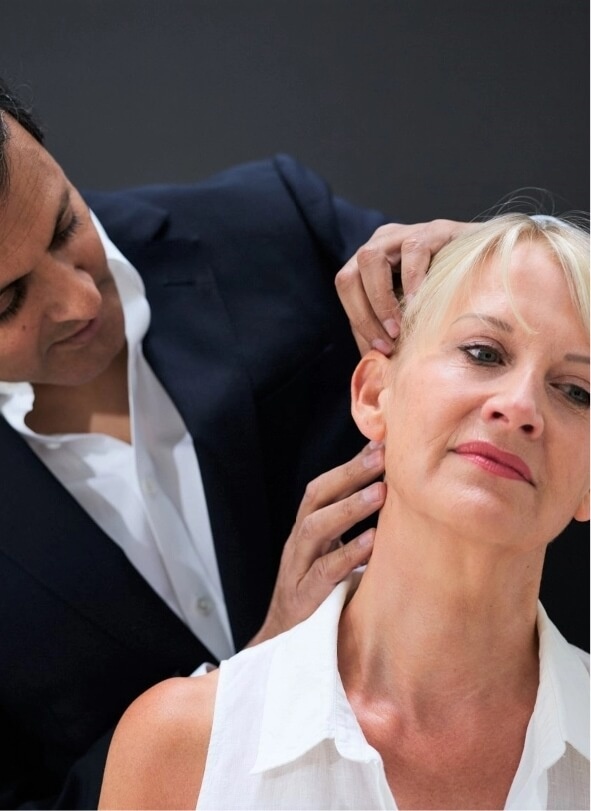 The uk's best facelift surgeon Rajiv Grover examining a facelift patient