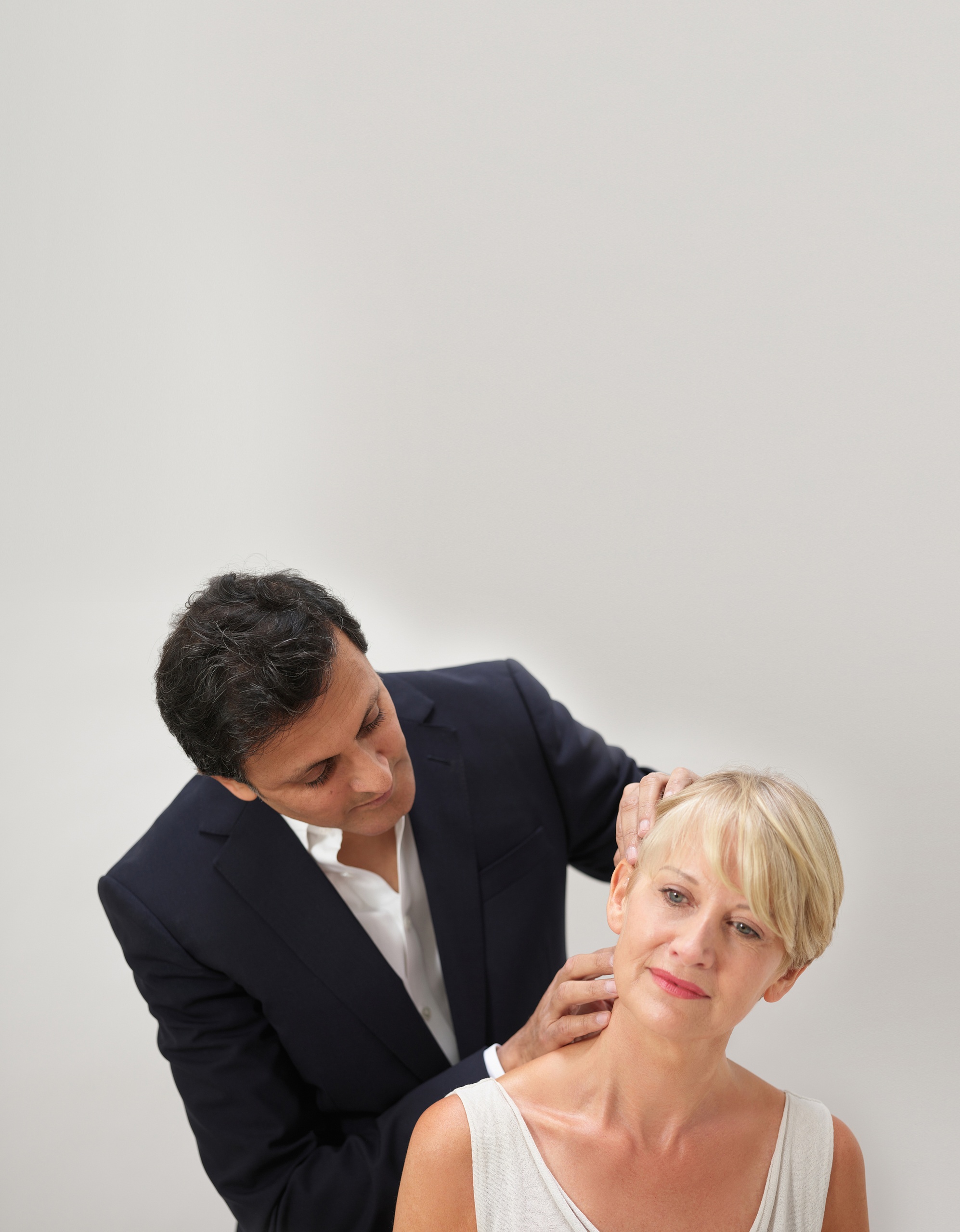 The uk's best facelift surgeon Rajiv Grover examining a facelift patient